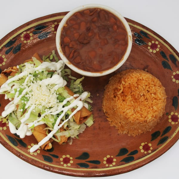 Speedy Tacos and Chicken's Mexican meal with taquitos, rice, and beans on a decorative plate.